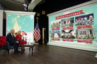 President Joe Biden, first lady Jill Biden and their new dog Commander, a purebred German shepherd puppy, meet virtually with service members around the world, Saturday, Dec. 25, 2021, in the South Court Auditorium on the White House campus in Washington, to thank them for their service and wish them a Merry Christmas. (AP Photo/Carolyn Kaster)