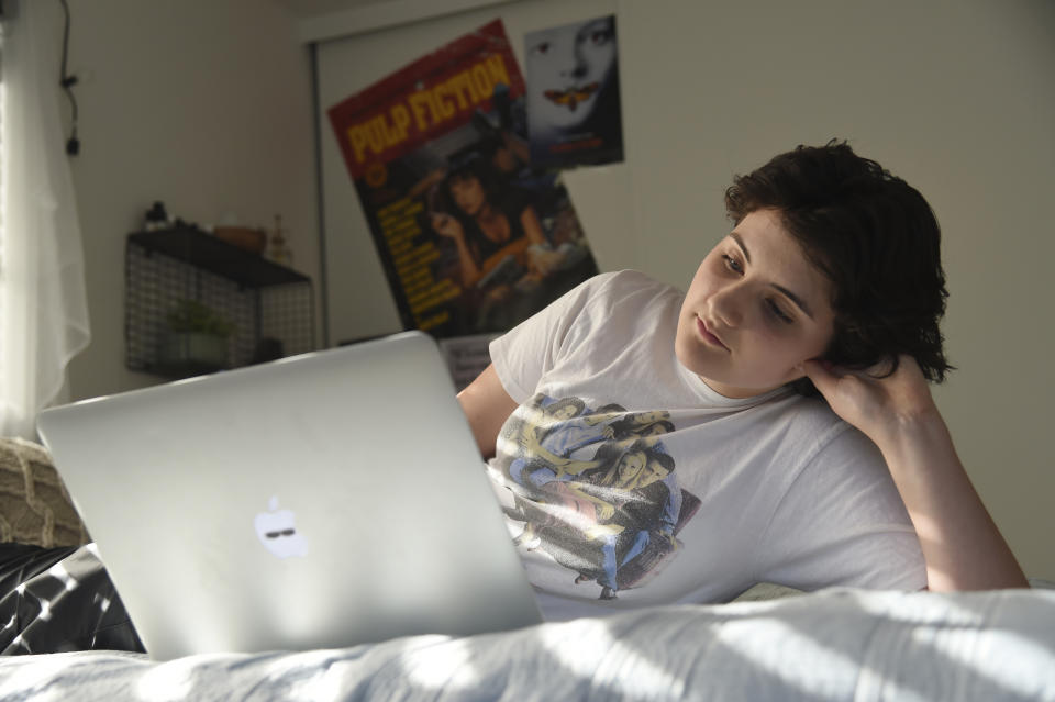 In this Thursday, Aug. 22, 2019 photo, Esme Goldman, 13, streams an episode of the '90s sitcom "Friends" via Netflix in her bedroom at her home, in Pasadena, Calif. “Friends” marks its 25th anniversary Sunday, Sept. 22 and the quintessential 1990s sitcom has attracted a new slew of viewers who are barely half that age. Tween and teen girls in particular have embraced the show with huge enthusiasm, taking a show that belonged to Generation X and making it their own. (Photo by Chris Pizzello/Invision/AP)