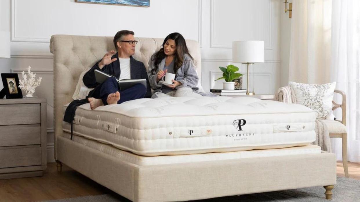  A couple sit on the brand new The Royal Bliss European Handcrafted Mattress. 