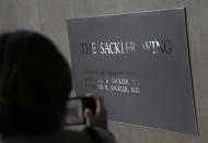 FILE - In this Jan. 17, 2019, file photo, a sign with some names of the Sackler family is displayed at the Metropolitan Museum of Art in New York. Their name used to be on a wing at the Louvre. But now the Sackler family wealth has become linked to sales of OxyContin, and their company, drug maker Purdue Pharma, is attempting to settle lawsuits over the opioid crisis. (AP Photo/Seth Wenig, File)
