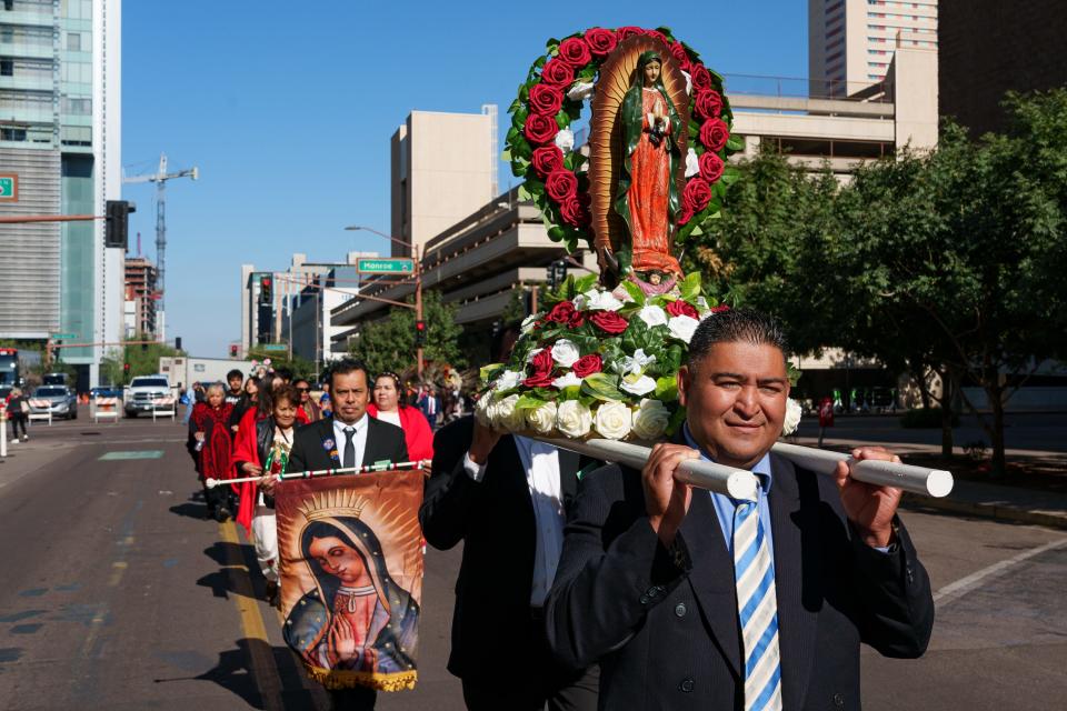 Hector Martinez holds a statue of Our Lady of Guadalupe during a procession put on by the Roman Catholic Diocese of Phoenix on Dec. 2, 2023, in Phoenix, to honor the Virgin Mary for the feast day of Our Lady of Guadalupe. The feast day is on Dec. 12.