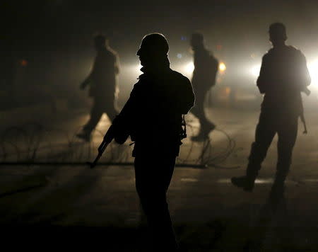 Afghan policeman keep watch near the site of a blast, in an area close to the Russian embassy in the west of the capital of Kabul, Afghanistan January 20, 2016. REUTERS/Ahmad Masood