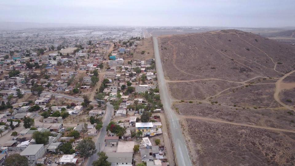An aerial photo showing houses and yards built up to the border fence in the Nido de las Aguilas section of Tijuana. (John Gibbins/San Diego Union-Tribune/TNS/Sipa USA)