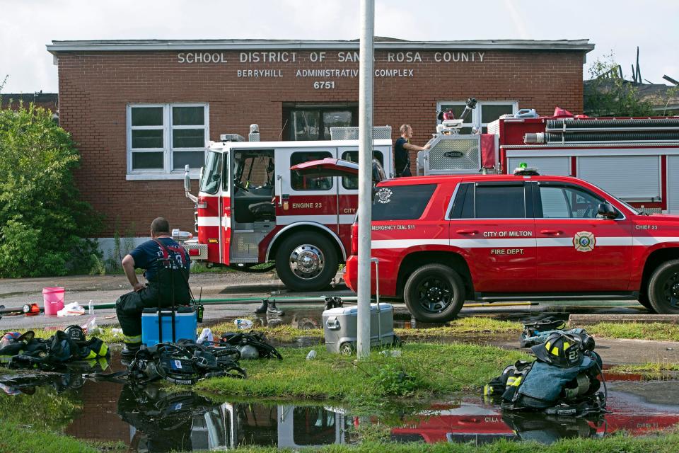 Santa Rosa County firefighters on Monday continue to work the scene of a fire that destroyed the historic Berryhill Elementary School in Milton. The fire started Sunday night.