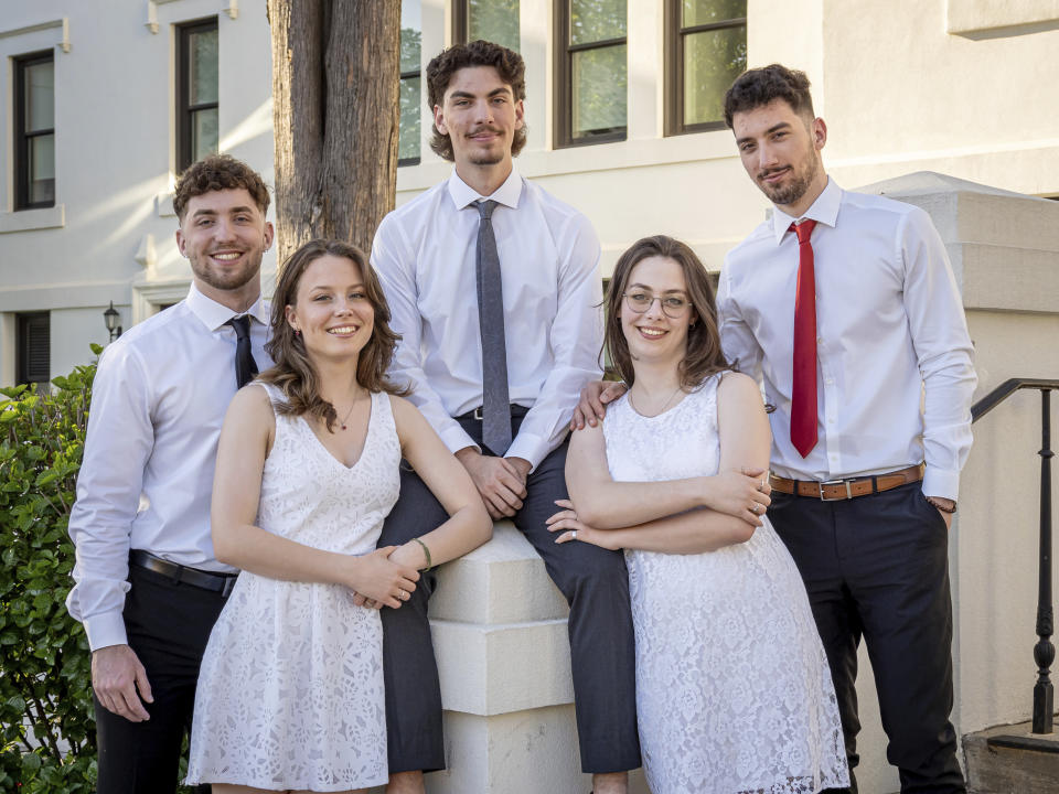 The Povolos quintuplets, from left; Ludovico, Victoria, Michael, Ashley and Marcus pose for a photo before the commencement ceremony at the Montclair State University, Monday, May 13, 2024, in Montclair, N.J. (Mike Peters/Montclair State University via AP)