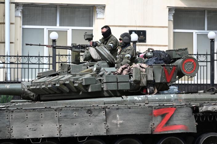 Fighters of Wagner private mercenary group are seen atop of an armoured vehicle in a street near the headquarters of the Southern Military District in the city of Rostov-on-Don, Russia, June 24, 2023.