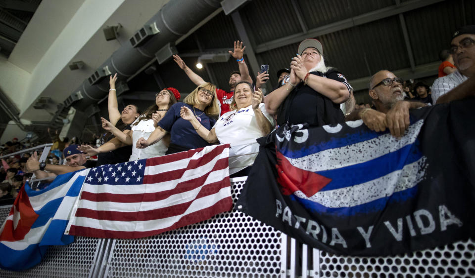 Fans dance during the first inning of a semifinal between Cuba and the United States at the World Baseball Classic on Sunday, March 19, 2023, in Miami. (Matias J. Ocner/Miami Herald via AP)