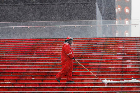 A worker clears snow during a snowstorm in the Times Square neighborhood of New York, U.S., February 12, 2019. REUTERS/Lucas Jackson