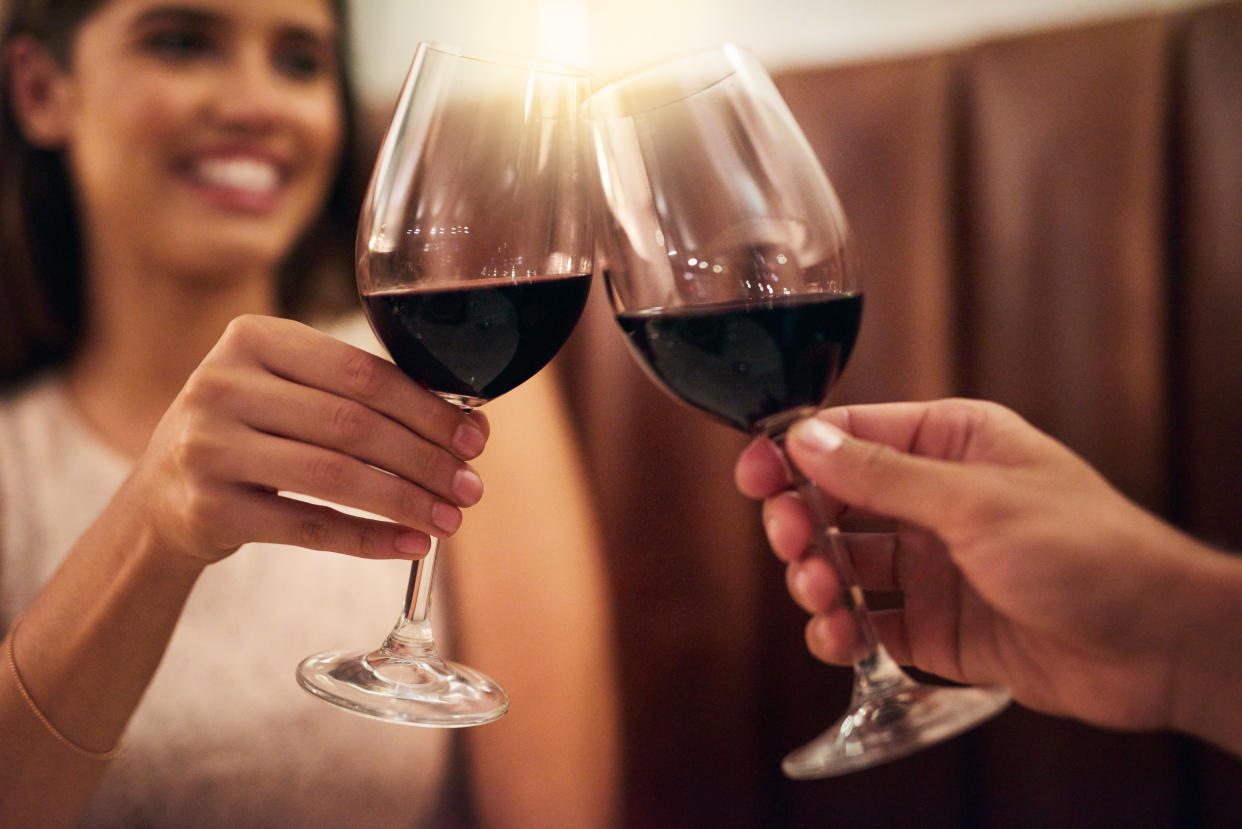 Cropped shot of a couple making a toast while on a romantic date