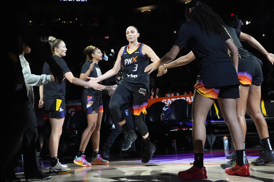 Phoenix Mercury defenseman Diana Taurasi (3) claps her teammates' hands during player introductions before a WNBA basketball game against the Seattle Storm, Thursday, Sept. 19, 2024, in Phoenix. (AP Photo/Ross D. Franklin)