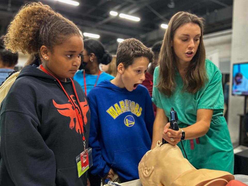 Students from Dr. Phinnize J. Fisher Middle School stop by a table where a nurse is demonstrating how to intubate a patient at the Greenville County Schools seventh grade career fair.