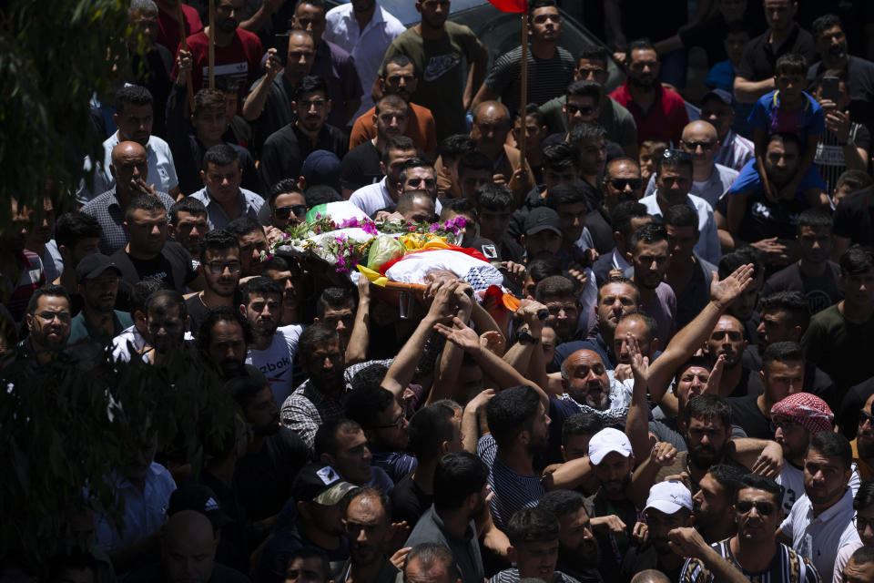 Palestinians carry the body of Mohammed al-Alami, 12, during his funeral in the village of Beit Ummar, near the West Bank city of Hebron, Thursday, July 29, 2021. Villagers say the boy was fatally shot by Israeli troops while traveling with his father in a car. The Israeli military has launched an investigation into the shooting. (AP Photo/Majdi Mohammed)