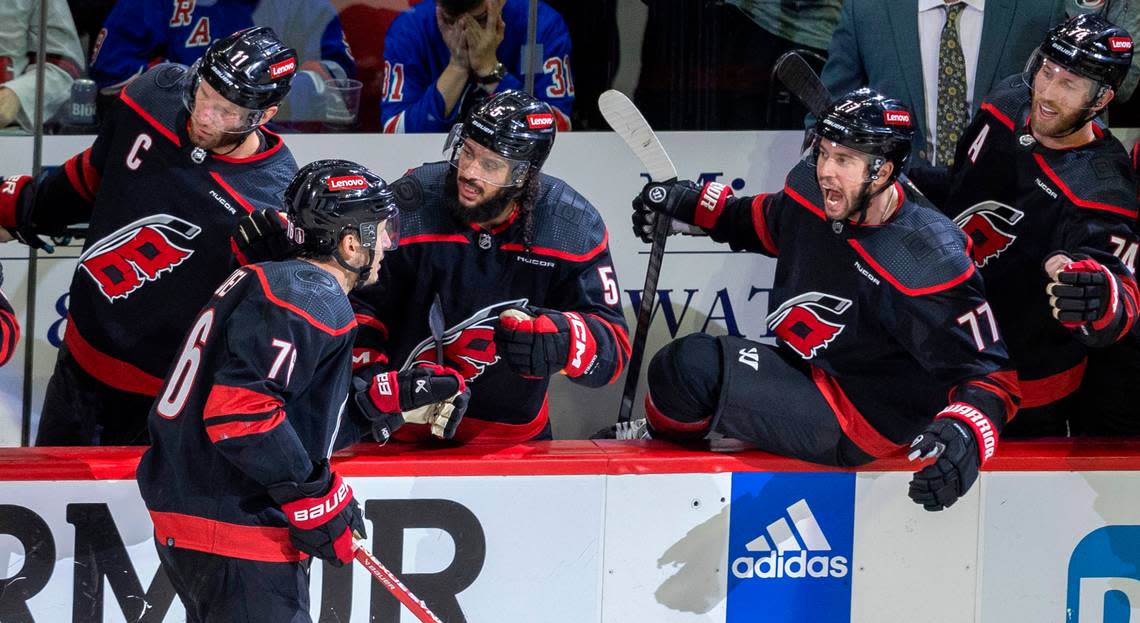 Carolina Hurricanes defenseman Brady Skjei (76) is greeted by teammate Tony DeAngelo (77) after scoring the game winning goal on a power play late in the third period to secure a 4-3 victory over the New York Rangers during Game 4 in the second round of the 2024 Stanley Cup playoffs on Saturday, May 11, 2024 at PNC Arena, in Raleigh N.C. Robert Willett/rwillett@newsobserver.com