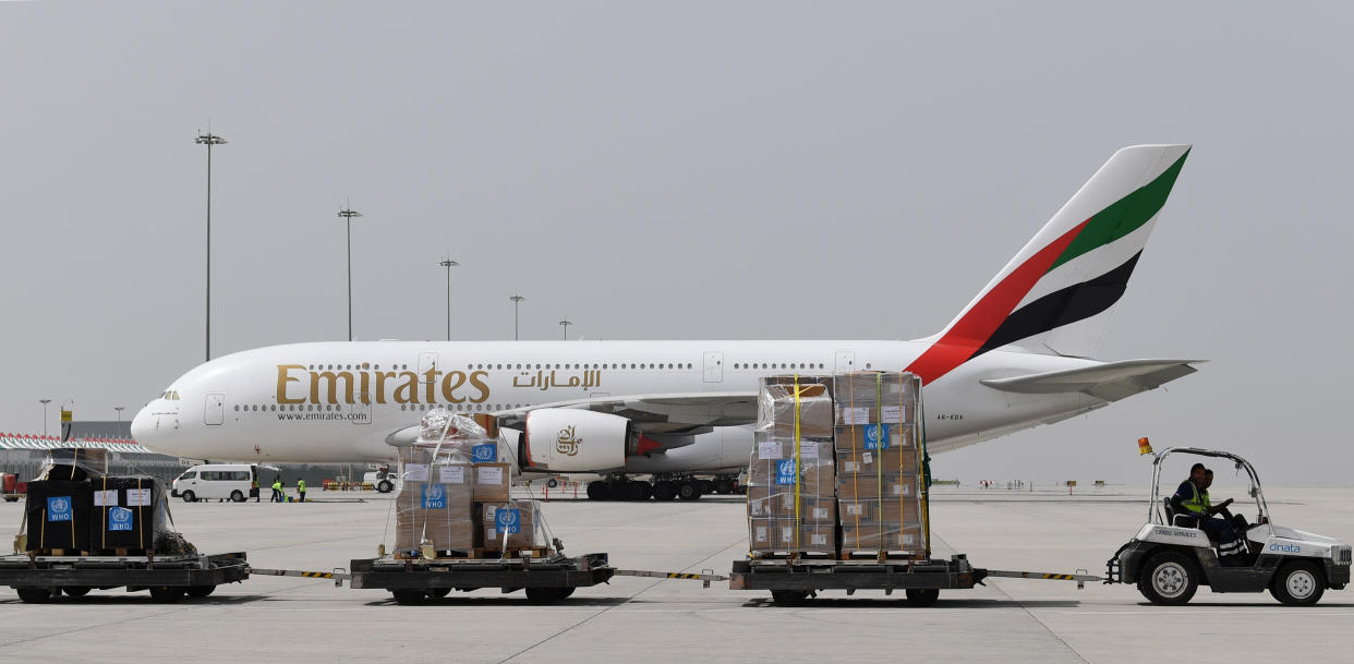 Tonnes of medical equipment and coronavirus testing kits provided bt the World Health Organisation are pictured passing by an Emirates airlines Airbus A380-861, at the al-Maktum International airport in Dubai on March 2, 2020 as it is prepared to be delivered to Iran with a United Arab Emirates military transport plane. (Photo by KARIM SAHIB / AFP) (Photo by KARIM SAHIB/AFP via Getty Images)
