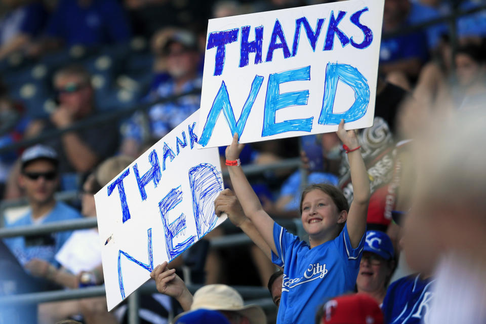 Fans hold signs honoring Kansas City Royals manager Ned Yost during the sixth inning of a baseball game against the Minnesota Twins at Kauffman Stadium in Kansas City, Mo., Sunday, Sept. 29, 2019. (AP Photo/Orlin Wagner)