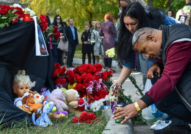 People laid flowers for victims of the shooting at a college in Kerch, Crimea