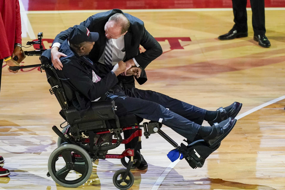 Former Wisconsin player and assistant coach Howard Moore is greeted by Wisconsin coach Greg Gard Saturday, March 2, 2024, in Madison, Wis., in in his first public appearance at the Kohl Center since a 2019 car wreck killed his wife and daughter and left him with serious injuries. (AP Photo/Andy Manis)