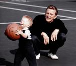 <p>Kirk Douglas looks on gleefully as his son Peter Vincent Douglas handles a basketball at their Los Angles home in 1957. </p>