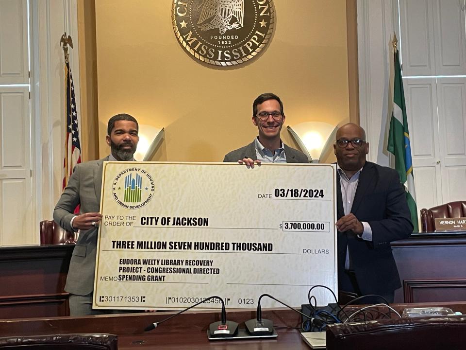 From Left: Jackson Mayor Chokwe Antar Lumumba, Peyton Smith, chairman of the JHLS Board of Trustees and Floyd Council, executive director of the JHLS, pose with a federal grant check that will be used to help with recovery efforts for the Eudora Welty Library.