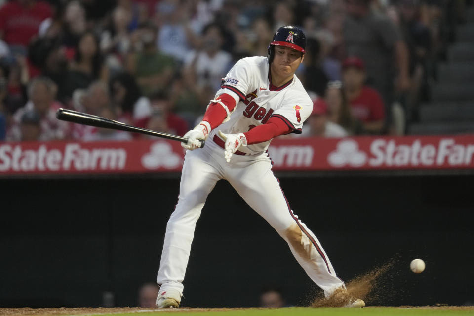 Los Angeles Angels' Shohei Ohtani (17) swings on a wild pitch before reaching first during the fifth inning of a baseball game against the Pittsburgh Pirates in Anaheim, Calif., Friday, July 21, 2023. (AP Photo/Ashley Landis)