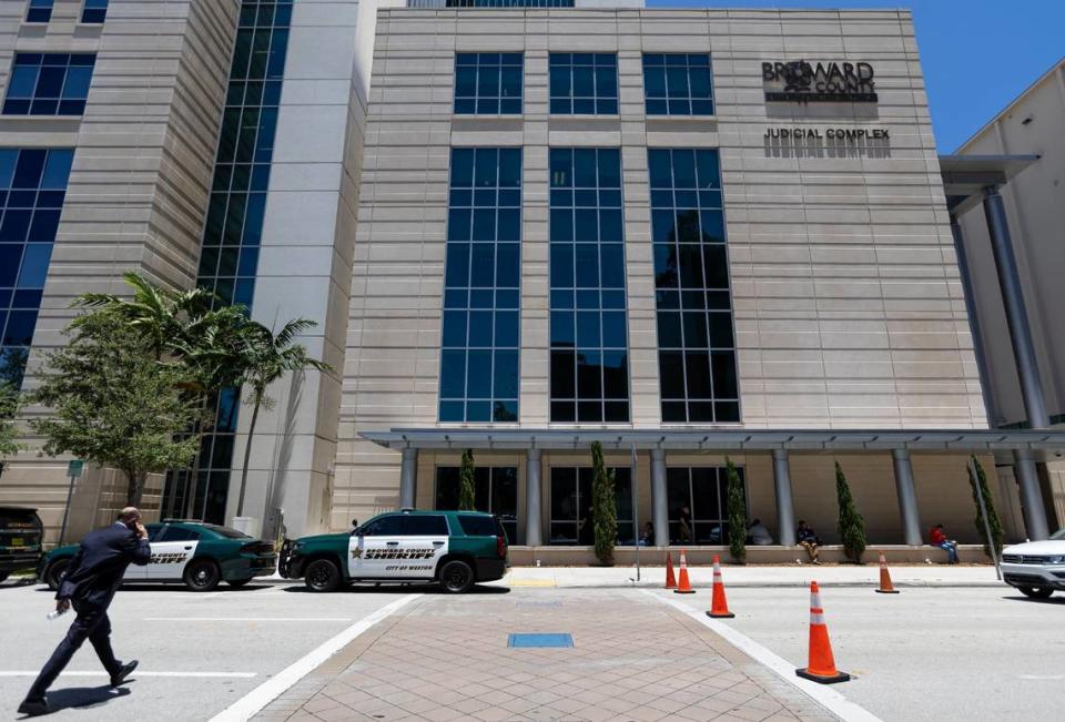 A man makes his way toward the Broward County Judicial Complex on Friday, May 24, 2024, in Fort Lauderdale, Fla.