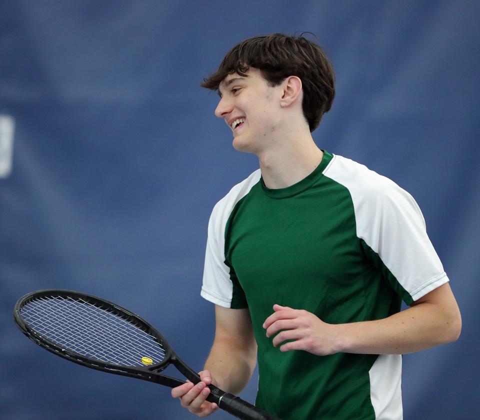 Firestone senior Reece Caraboolad is all smiles as he competes in the City Series tournament at Towpath Tennis Center, Wednesday, May 3, 2023.