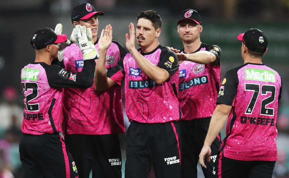 Sydney Sixers teammates, pictured here getting around Ben Dwarshuis in the BBL.