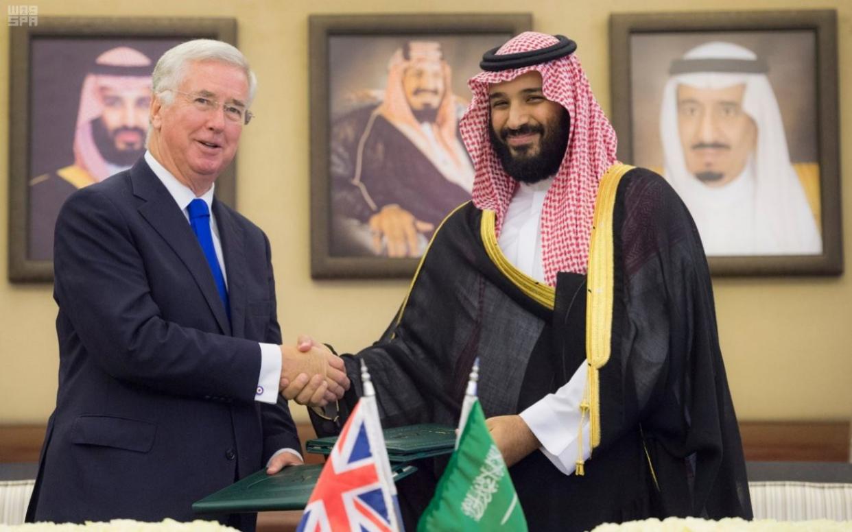 Saudi Crown Prince Mohammed bin Salman shakes hands with British Defence Secretary Michael Fallon after signing agreements in Jeddah - REUTERS