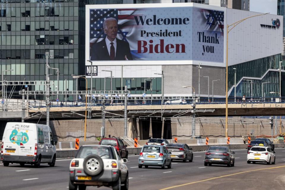 A photo including a billboard welcoming US President Joe Biden in Tel Aviv