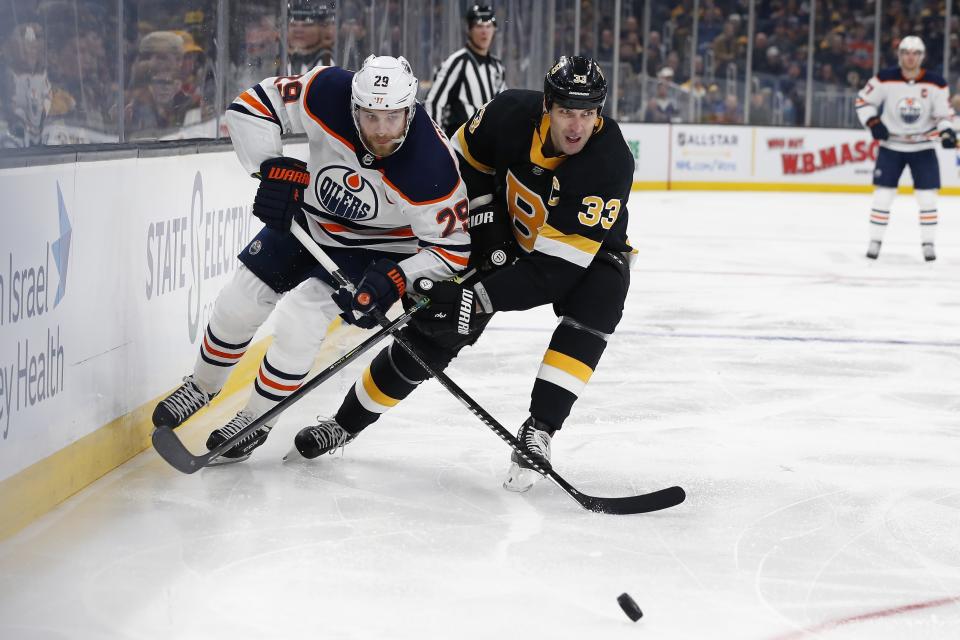 Edmonton Oilers' Leon Draisaitl (29) ad Boston Bruins' Zdeno Chara (33) battle for the puck during the second period on an NHL hockey game in Boston, Saturday, Jan. 4, 2020. (AP Photo/Michael Dwyer)