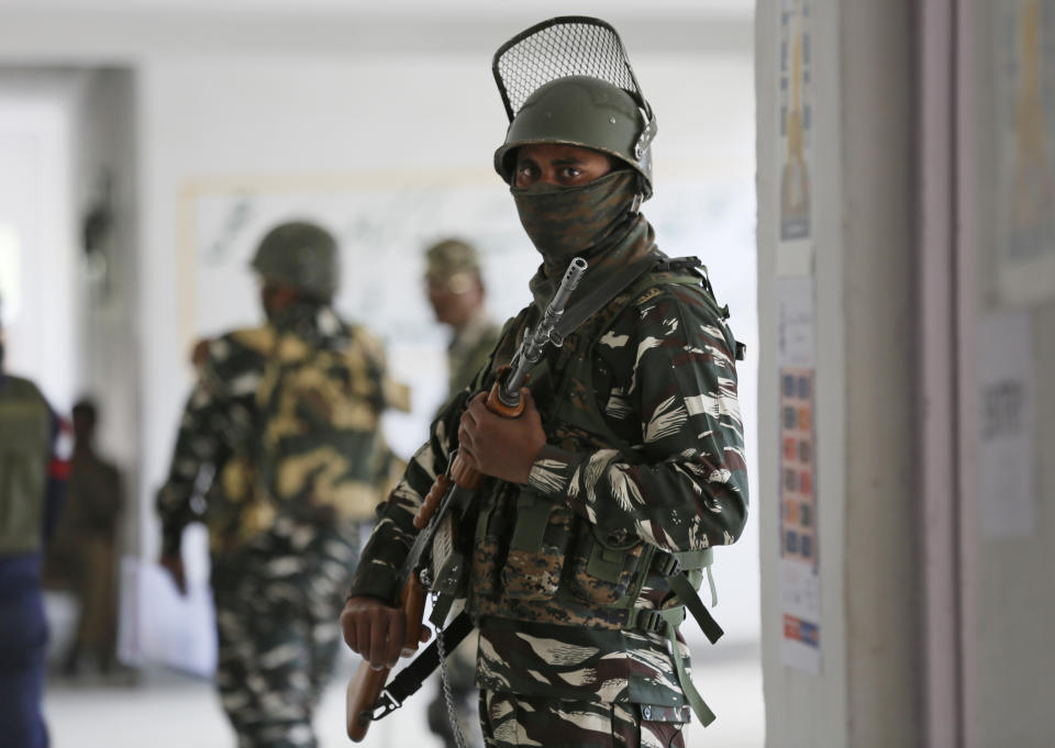 An Indian paramilitary soldier stands guard inside a polling station during the third phase of India's general elections at Verinag, south of Srinagar, Indian controlled Kashmir, Tuesday, April 23, 2019. Kashmiri separatist leaders who challenge India's sovereignty over the disputed region have called for a boycott of the vote. (AP Photo/Mukhtar Khan)