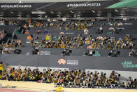 Photographers shoot the Women's 100-meter final during the World Athletics Championships in Budapest, Hungary, Monday, Aug. 21, 2023. (AP Photo/Matthias Schrader)