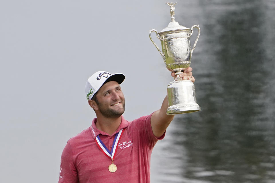 Jon Rahm, of Spain, holds the champions trophy for photographers after the final round of the U.S. Open Golf Championship, Sunday, June 20, 2021, at Torrey Pines Golf Course in San Diego. (AP Photo/Jae C. Hong)