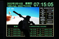 FILE - An Olympic skier walks past an information board showing the weather conditions at the bottom of the gondola station at the alpine skiing venue during the 2022 Winter Olympics, Thursday, Feb. 10, 2022, in the Yanqing district of Beijing. The dearth of candidates to host the Winter Olympics amid spiraling venue costs could force the IOC to resort to lining up a list of fixed, rotating hosts. A highly theoretical list could include Salt Lake City and Vancouver in North America, Pyeongchang in Asia and places like Switzerland, Italy and Scandinavia in Europe. (AP Photo/Robert F. Bukaty, File)