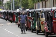 A man participates in a protest outside a police station demanding petrol in Colombo, Sri Lanka, Saturday, May 14, 2022. Sri Lankans have been forced to wait in long lines to purchase scarce imported essentials such as medicines, fuel, cooking gas and food because of a severe foreign currency shortage. (AP Photo/Eranga Jayawardena)