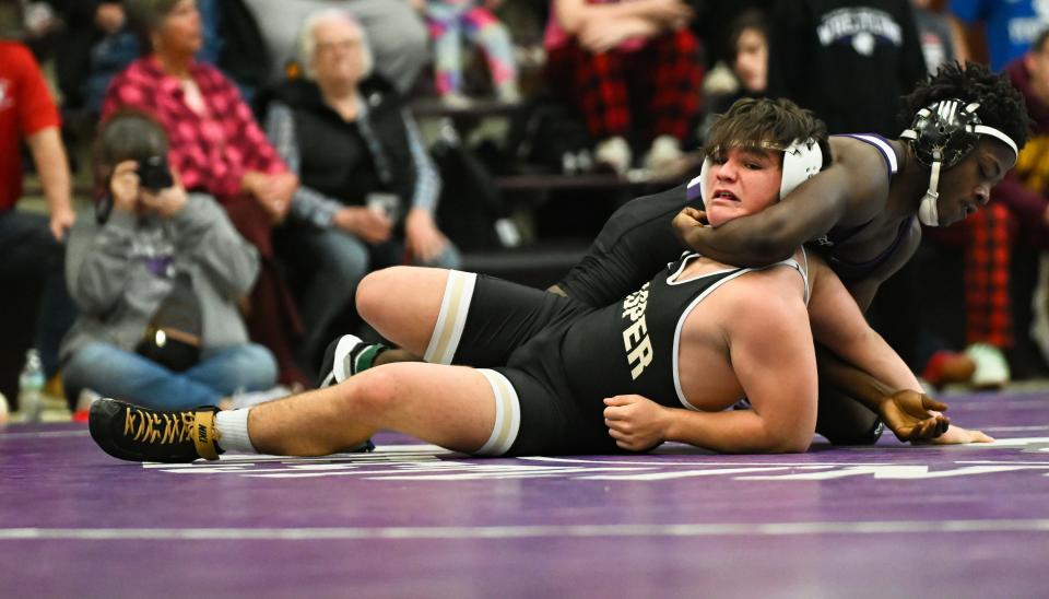 Bloomington South’s Tristian Hicks (back) wrestles against Jasper’s Mason Gegogeine in the 175-pound first round during the IHSAA wrestling regional at Bloomington South on Saturday, Feb. 3, 2024.