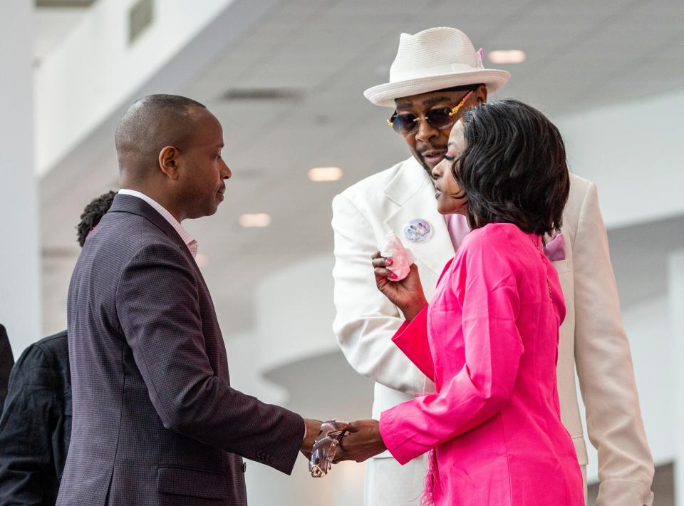 Milwaukee Mayor Cavalier Johnson, left, speaks with Sheena Scarbrough, right, mother of Sade Robinson, as she arrives to a public memorial service for her daughter Friday at the Baird Center in Milwaukee.