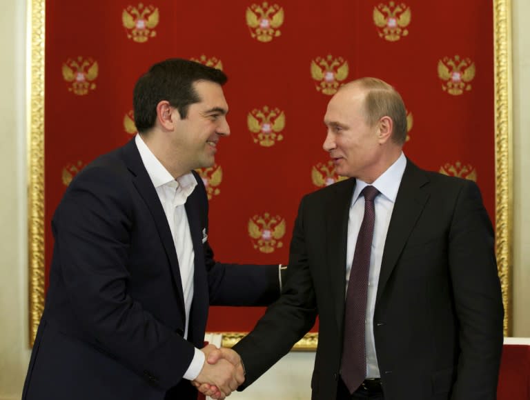 Greek Prime Minister Alexis Tsipras (L) shakes hands with Russian President Vladimir Putin during a signing ceremony at the Kremlin in Moscow on April 8, 2015