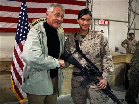 U.S. Defense Secretary Chuck Hagel (L) poses for a picture with U.S. Marine Jessica Pantoja as he visits the troops at Camp Bastion, Helmand province December 8, 2013. REUTERS/Mark Wilson/Pool