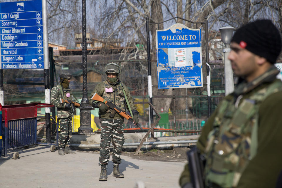 Indian paramilitary soldiers stand guard near a temporary check point during a strike in Srinagar, Indian controlled Kashmir, Sunday, Feb. 3, 2019. India's prime minster is in disputed Kashmir for a daylong visit Sunday to review development work as separatists fighting Indian rule called for a shutdown in the Himalayan region. (AP Photo/Dar Yasin)