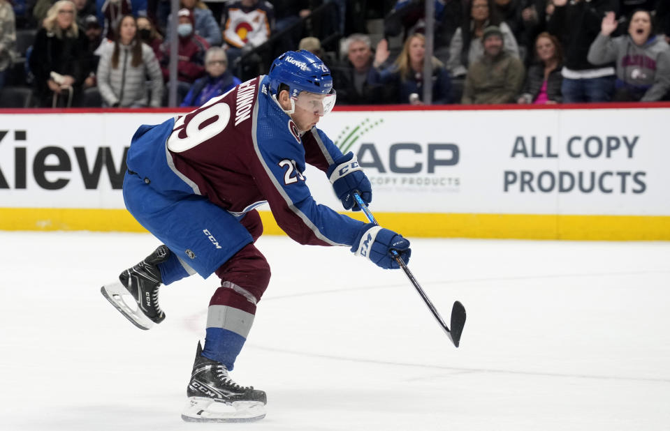 Colorado Avalanche center Nathan MacKinnon shoots the puck to score the go-ahead goal in the third period of an NHL hockey game against the Calgary Flames, Monday, Dec. 11, 2023, in Denver. (AP Photo/David Zalubowski)
