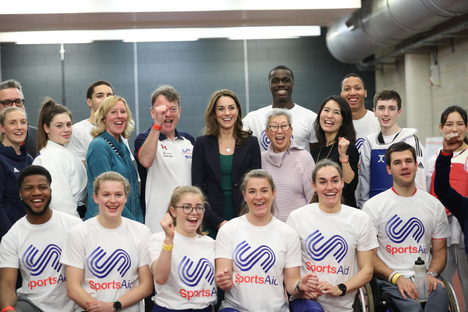 The Duchess of Cambridge (centre) poses for a photograph with young athletes and staff during a SportsAid event at the London Stadium in Stratford, London.