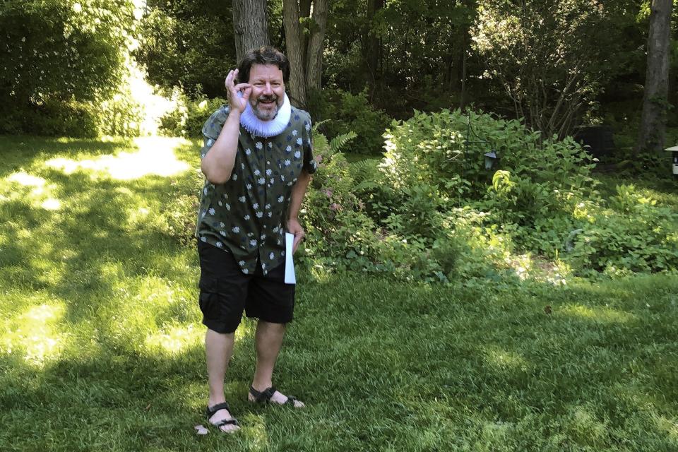 John Nagle, of the Vermont Shakespeare Festival, performs "Shakespeare," in a backyard, Thursday, June 25, 2020, in Burlington, Vt. The idea for the program, known as "Shakespeare to You," or "Bard to Your Yard," was conceived as a way to keep live theater alive at a time when many social activities are being postponed or canceled amid the coronavirus pandemic. (AP Photo/Wilson Ring)