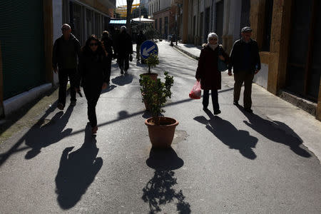 People cross Ledra's checkpoint of the United Nations patrolled "green line" in Nicosia, Cyprus January 18, 2017. REUTERS/Yiannis Kourtoglou