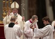 Pope Francis blesses at the end of the Christmas night mass in the Saint Peter's Basilica at the Vatican December 24, 2013. REUTERS/Tony Gentile