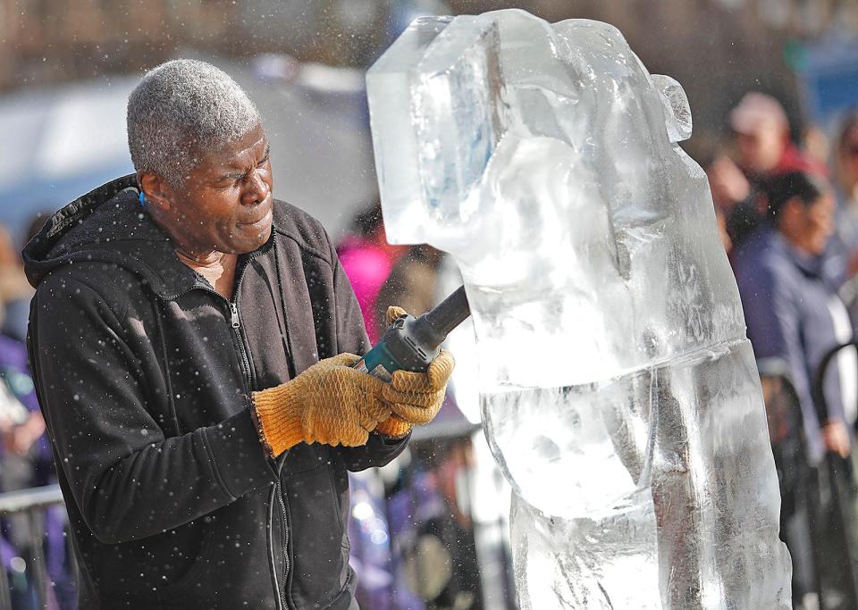 Sam Sonnie of Images in Ice in Brockton tries to beat the heat and carve a polar bear in ice blocks.