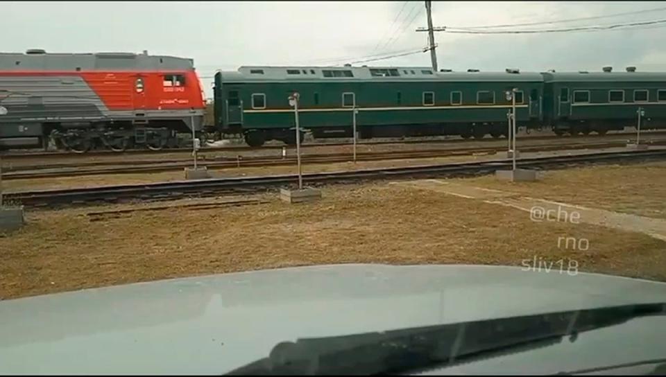 In this photo taken from video released by telegram channel @primamedia on 12 September, a green train with yellow trimmings, resembling one used by Kim Jong-un on his previous travels, is seen steaming near Khasan, about 127km south of Vladivostok (AP)