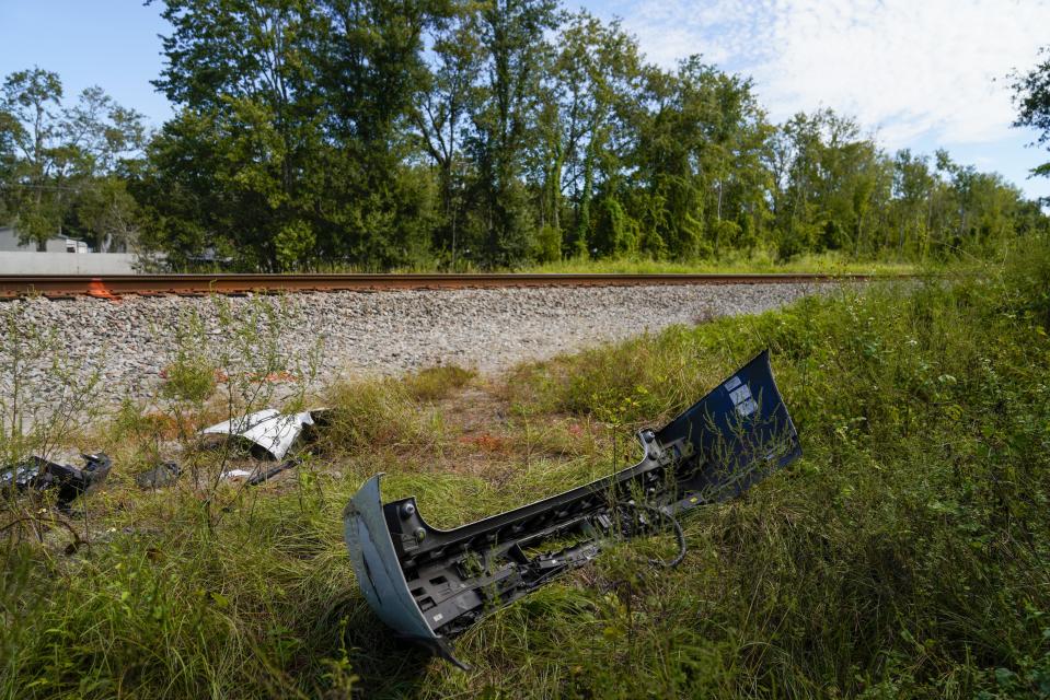 Remains of a vehicle are pictured Monday, Sept. 25, 2023 in Plant City, Fla., at the site of a weekend fatal train collision that killed six people and left another in critical condition, when they were crossing the train tracks, on their way to a birthday party. The weekend crash between a train and a sports-utility vehicle that killed six people in Florida happened at a private road crossing where little more than a sign or two is required, no crossing gates, no flashing lights, no sound. (Martha Asencio-Rhine/Tampa Bay Times via AP)