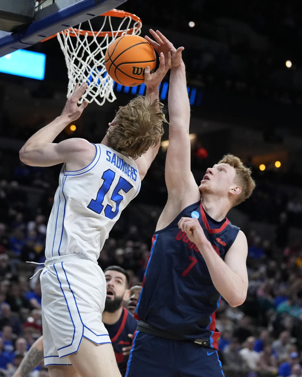 Duquesne forward Jakub Necas (7) fouls BYU guard Richie Saunders (15) in the first half of a first-round college basketball game in the NCAA Tournament, Thursday, March 21, 2024, in Omaha, Neb. (AP Photo/Charlie Neibergall)