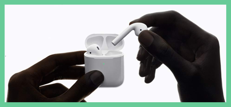 Hands holding Apple AirPods